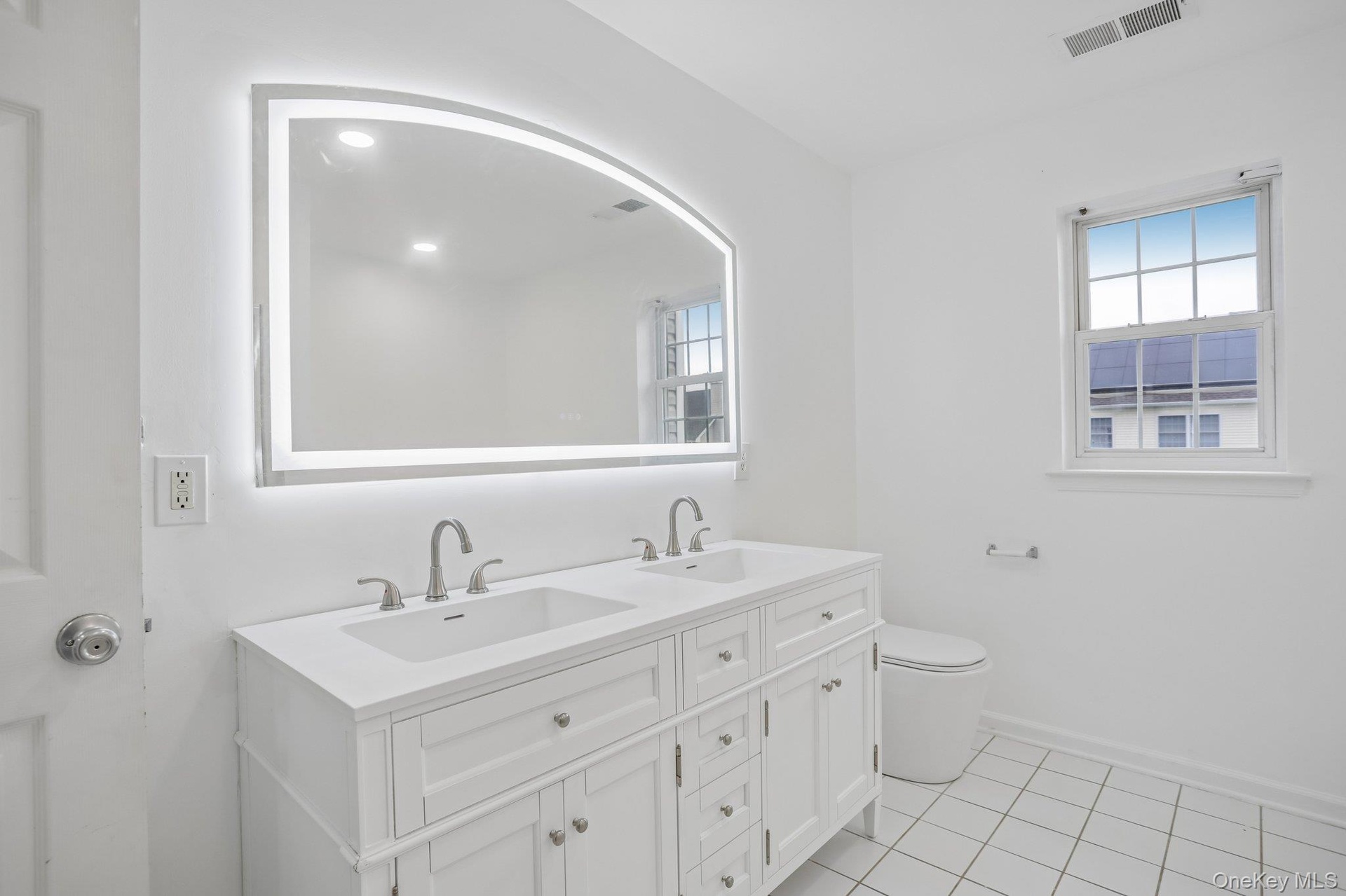 Brand new dual-sink cabinet, mirror and new toilet