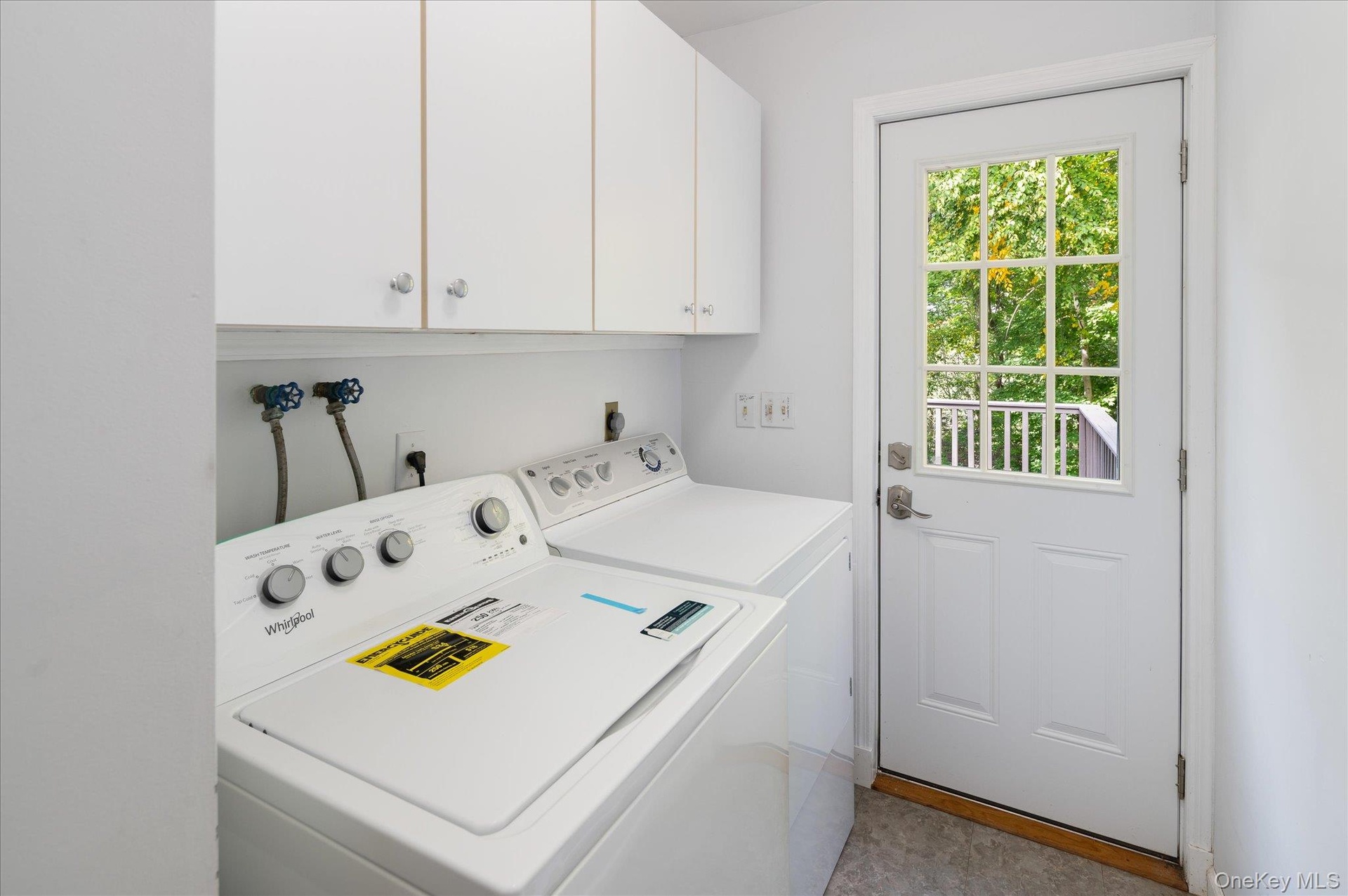 Main level laundry room with door to deck
