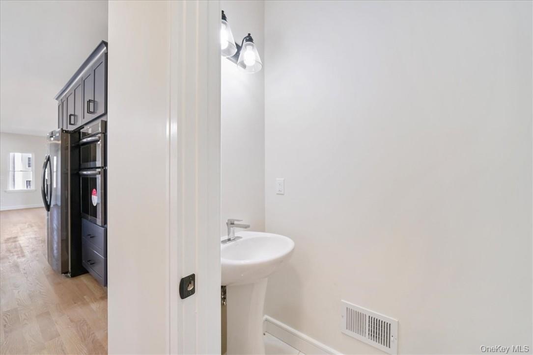 Bathroom with hardwood / wood-style floors