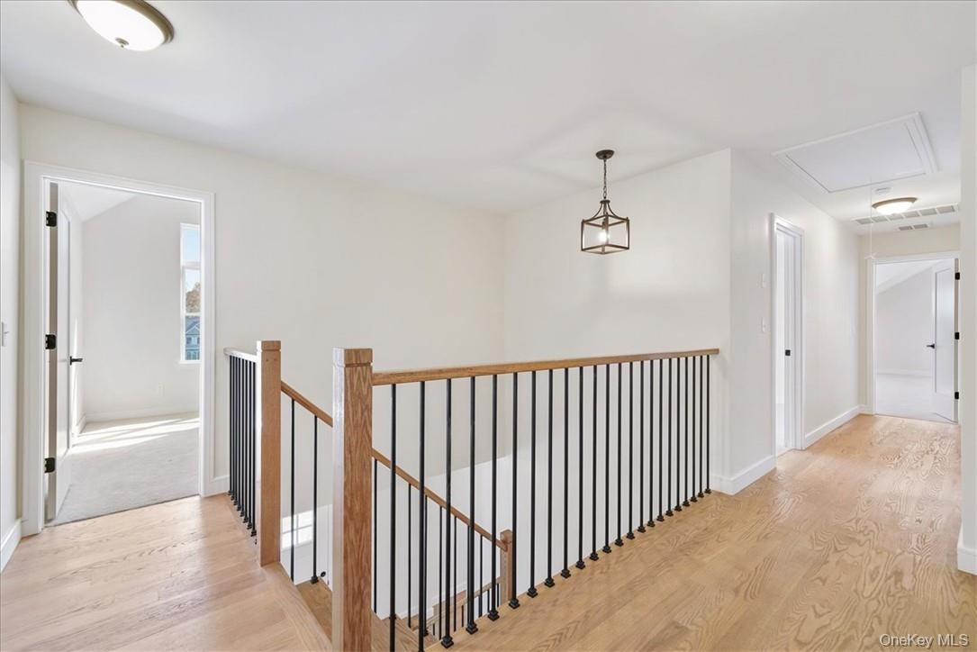 Hall with light hardwood / wood-style flooring