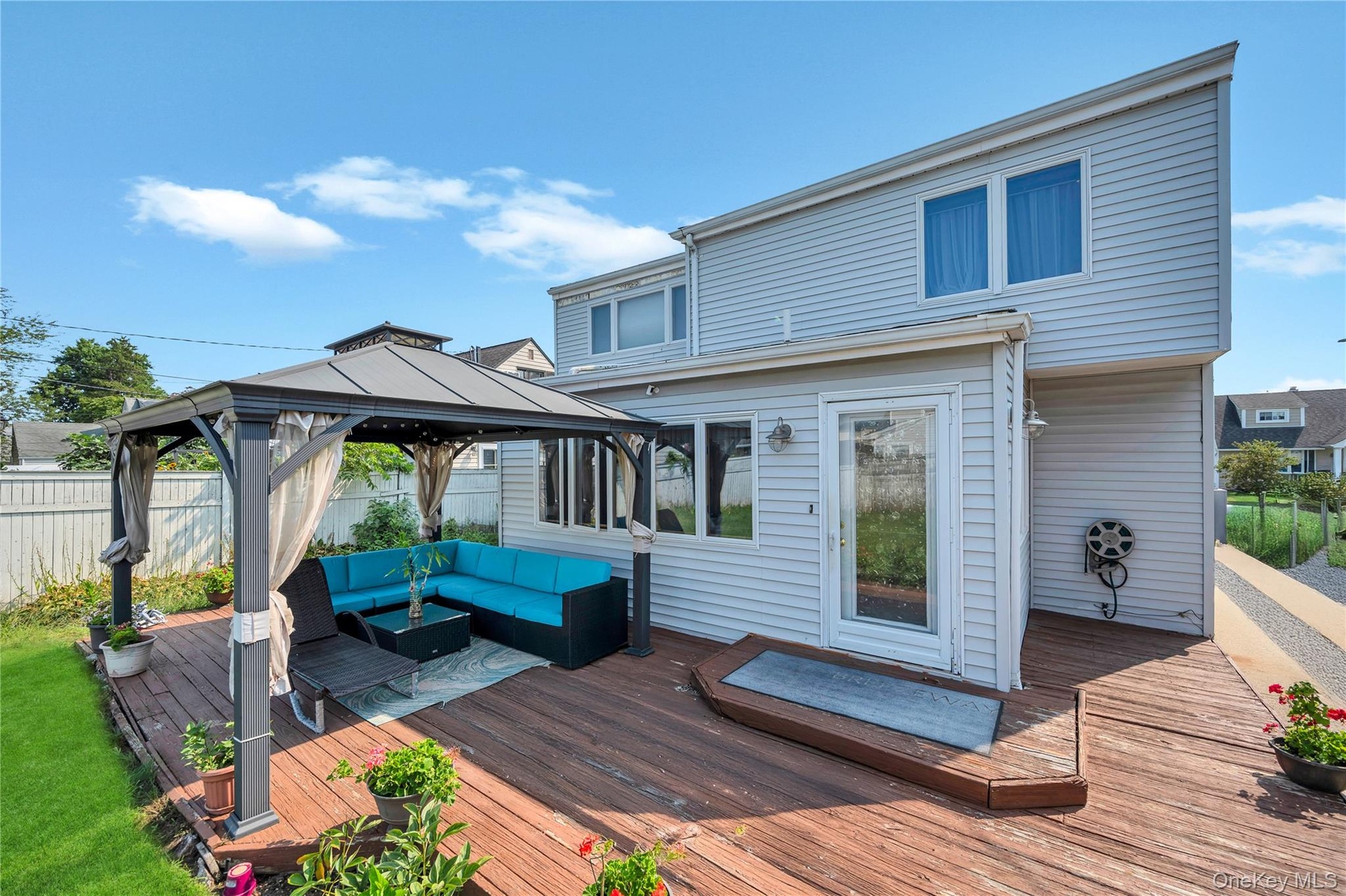 Wooden terrace featuring an outdoor hangout area and a gazebo