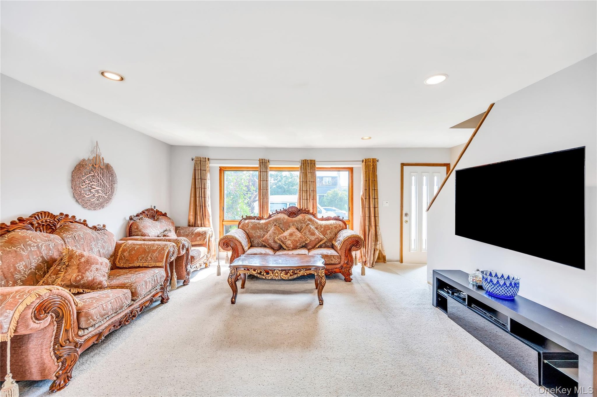 Living room with carpet flooring and recessed lighting