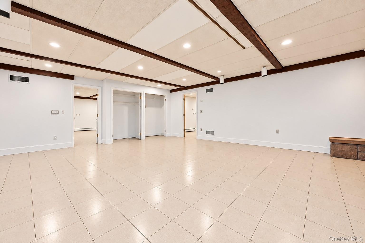 Lower level family room. Vinyl tile floor, large closets, door to large mudroom and garage.