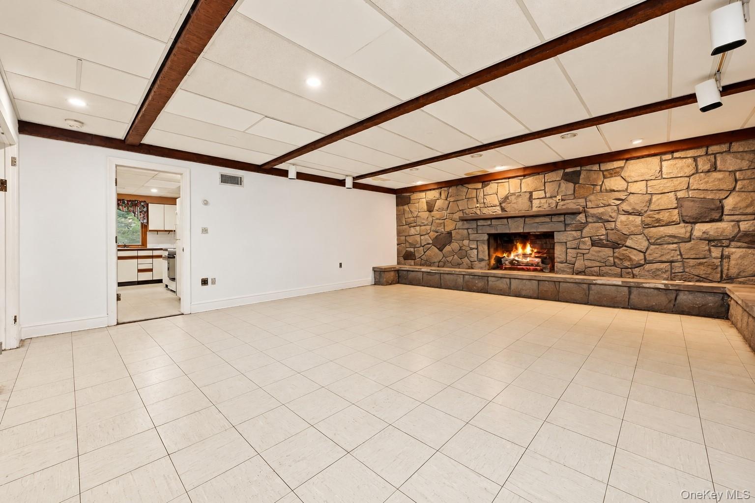Another view of the family room looking into the summer kitchen.Extraneous objects removed.