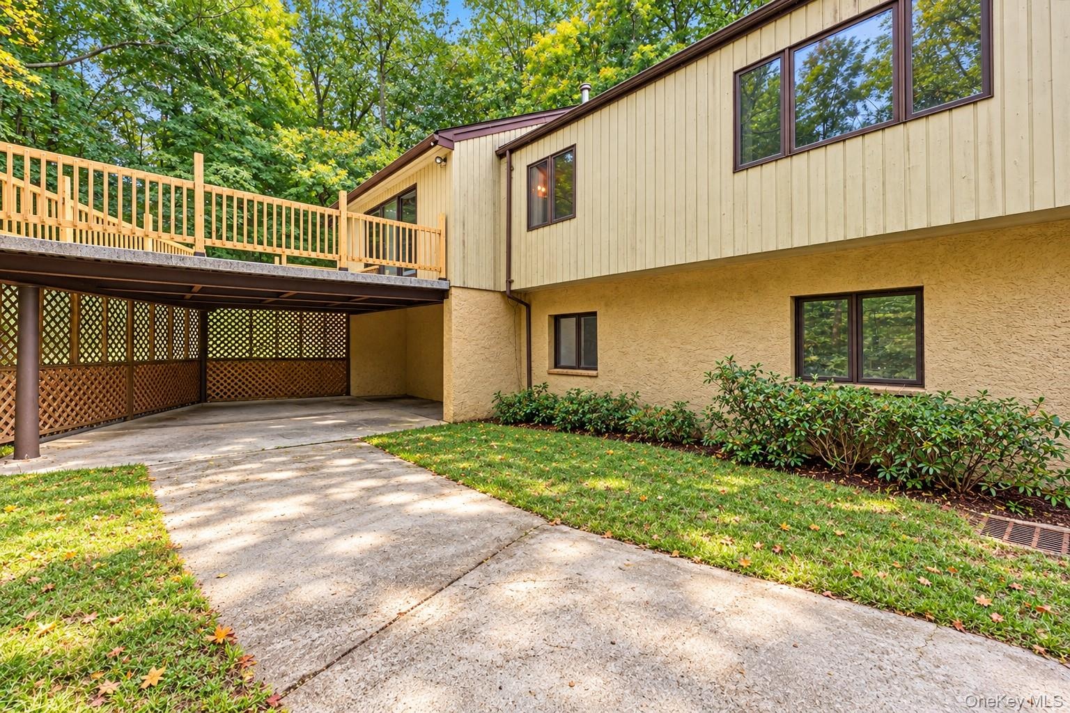 New deck over patio.  Deck is accessed from dining room and patio is accessed through lower level office/kitchen area.  Extraneous objects removed and