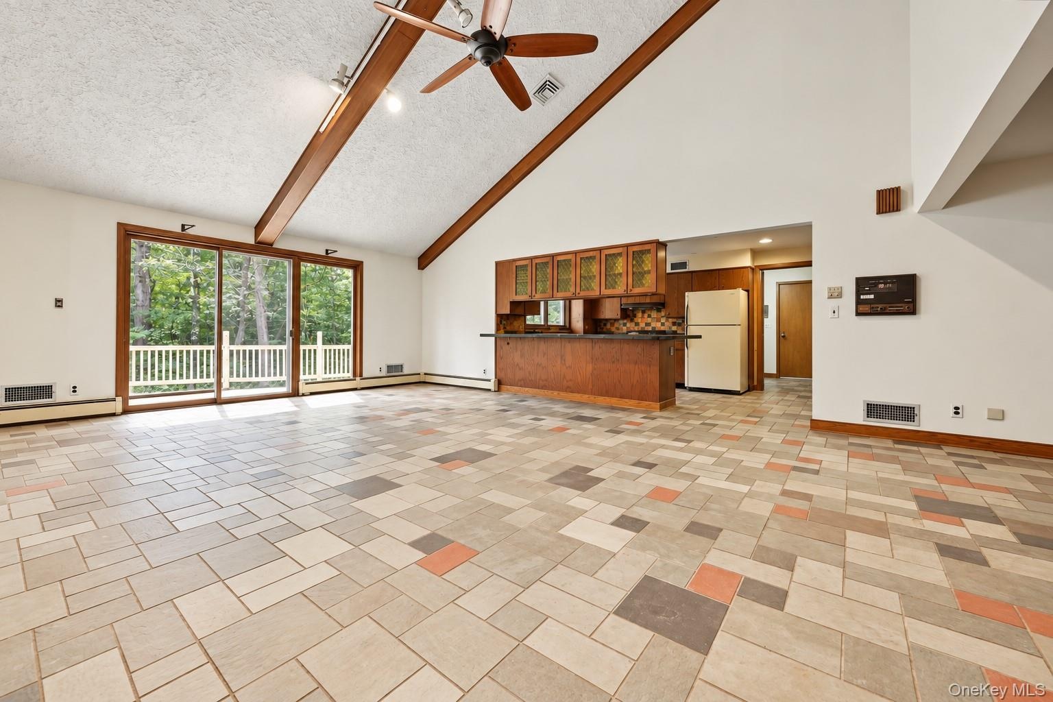 Sliding glass doors to new deck, open to kitchen, cathedral ceiling