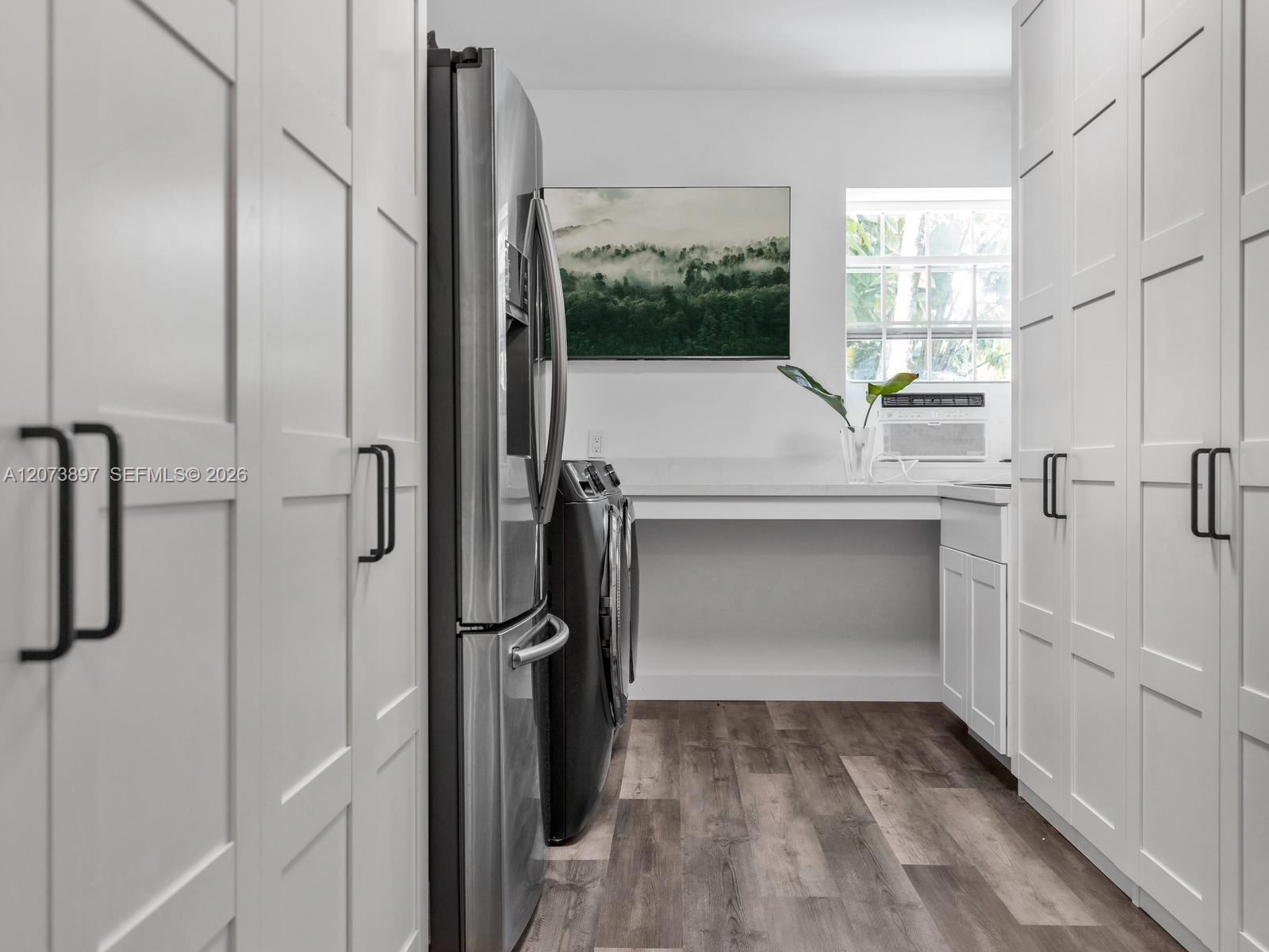 Oversized Laundry Room with Extra Refrigerator and Ample Storage