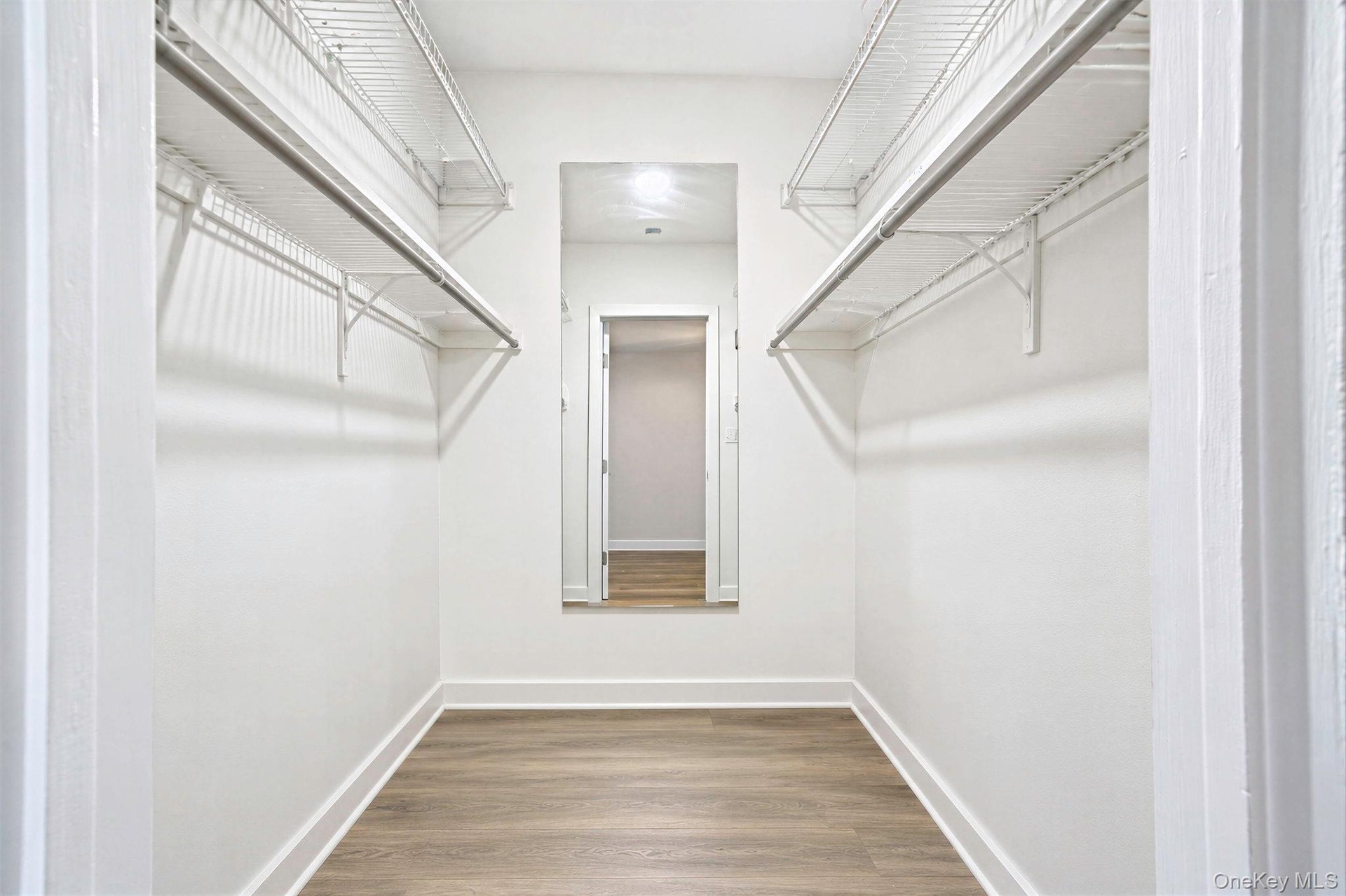 Primary bedroom walk in closet