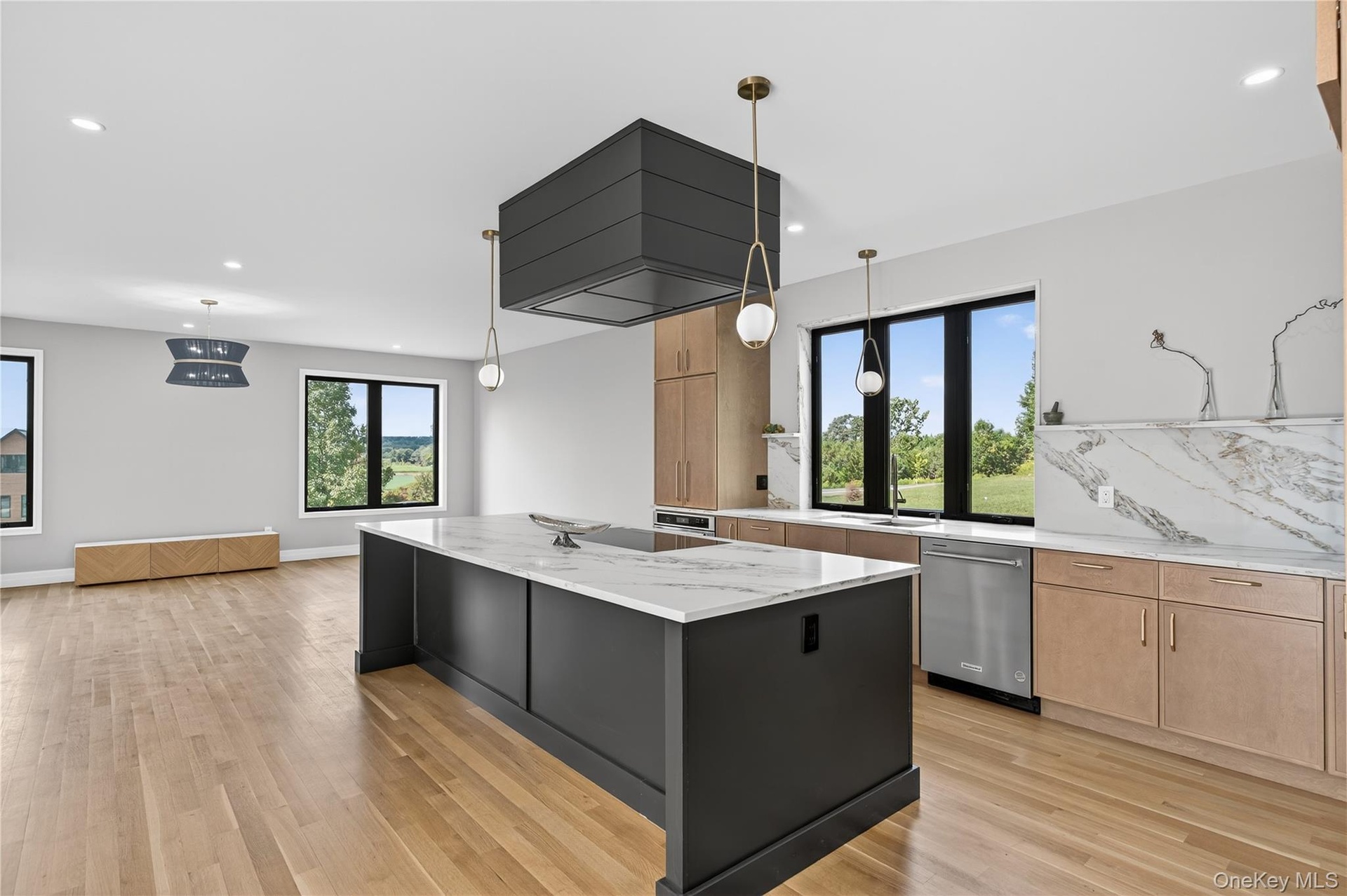 Kitchen featuring light brown cabinetry, stainless steel appliances, light stone counters, healthy amount of natural light, and recessed lighting