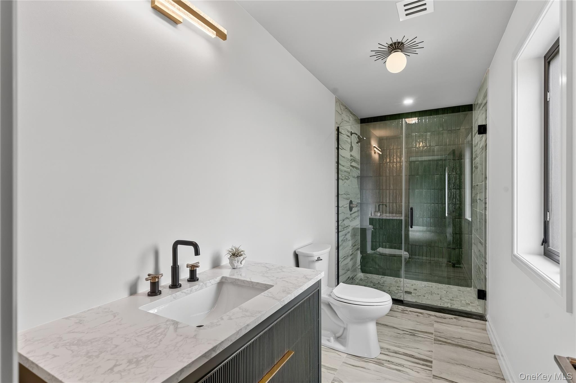 Bathroom featuring a shower stall, vanity, and recessed lighting