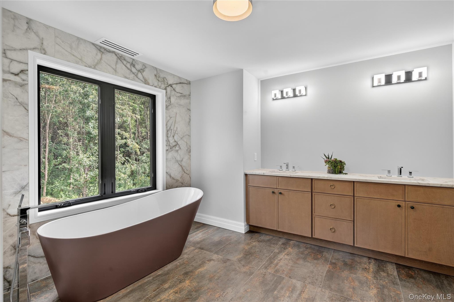 Bathroom featuring a soaking tub and double vanity