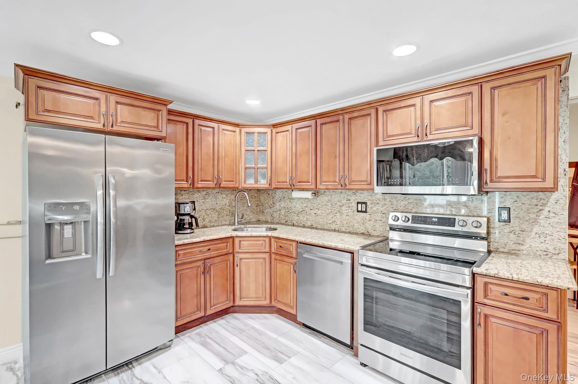 Cabinet lined kitchen with stainless steel appliances