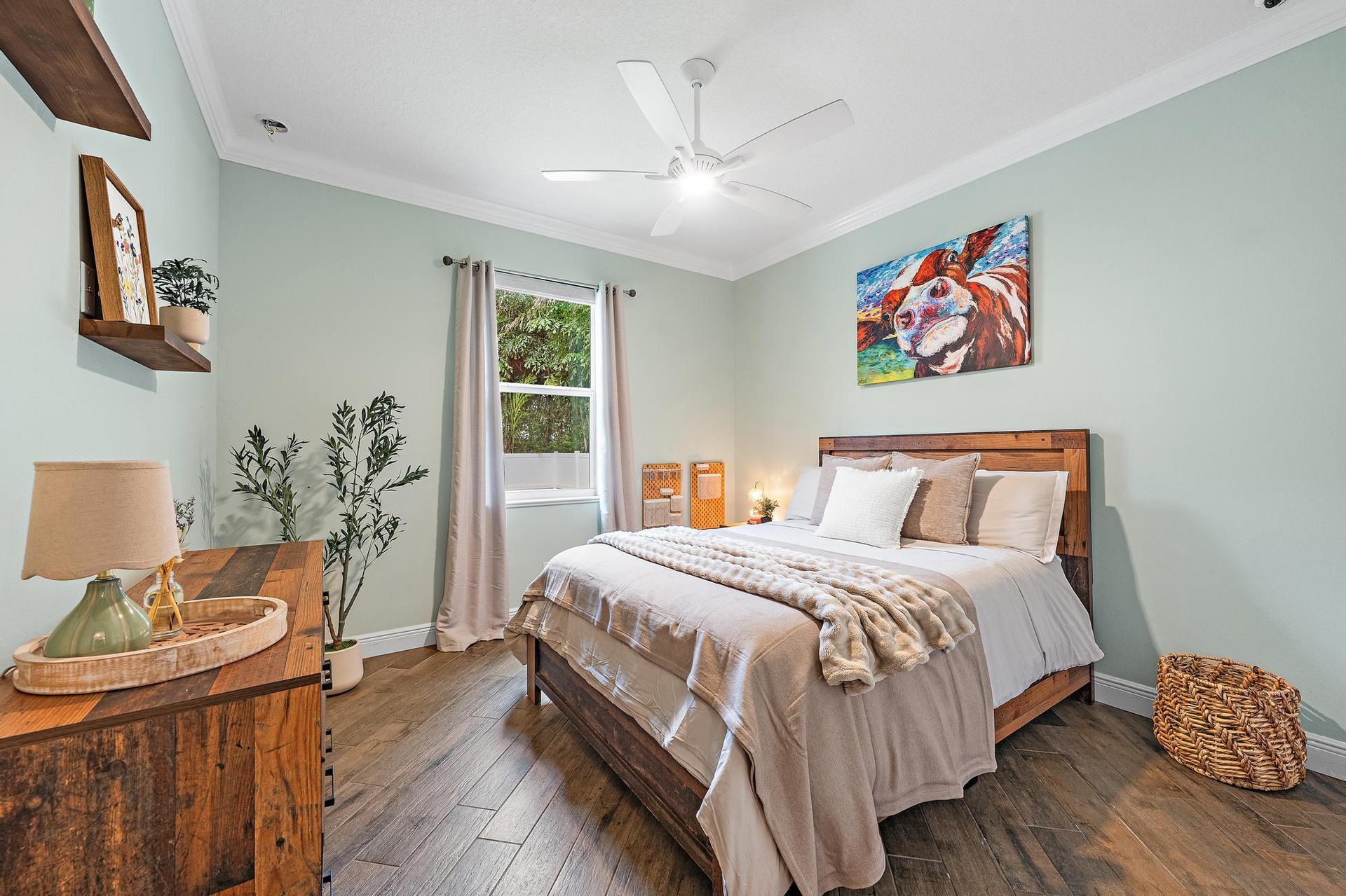 This Bedroom boasts a Queen Bed with view of the back yard space + has a custom built closet as well!