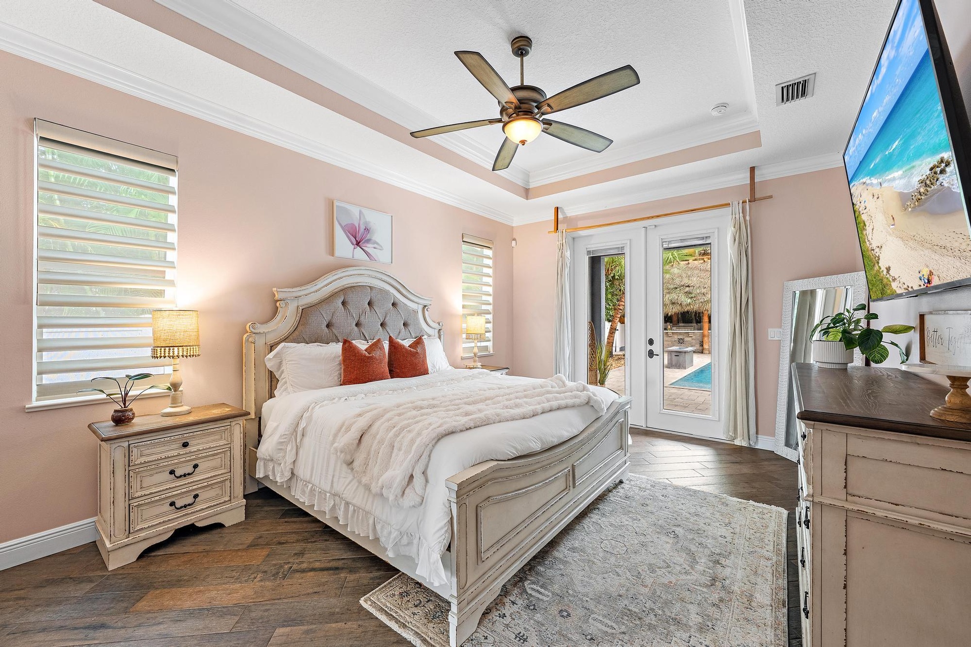 Welcome to the Expansive Primary Suite with Double Door View of the Pool + Tiki + Patio!