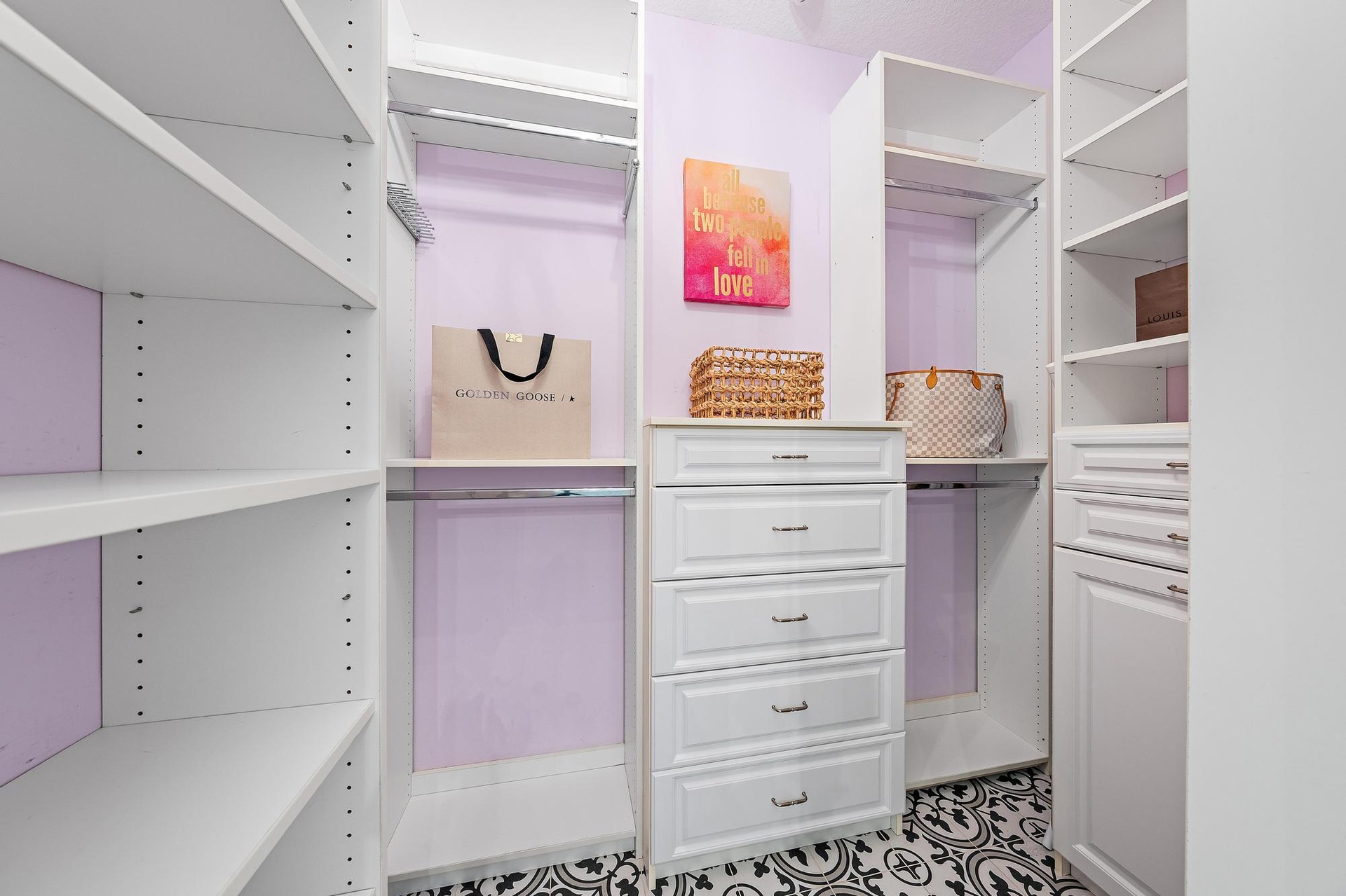 Ample storage in the Primary Walk-In Closet complete with the most perfect chandelier!