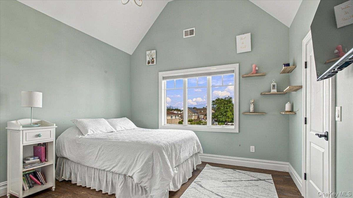 Bedroom with soaring ceilings, water view