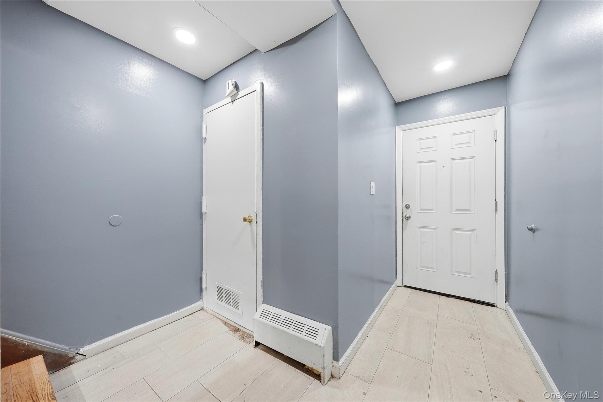 Entryway featuring light-colored flooring and recessed lighting
