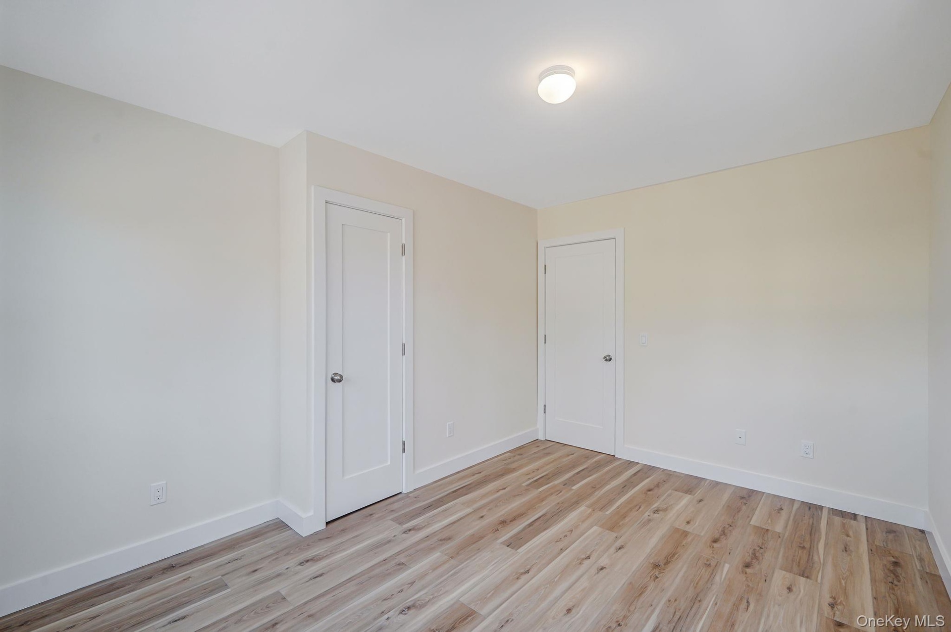 Unfurnished room featuring baseboards and light wood-type flooring