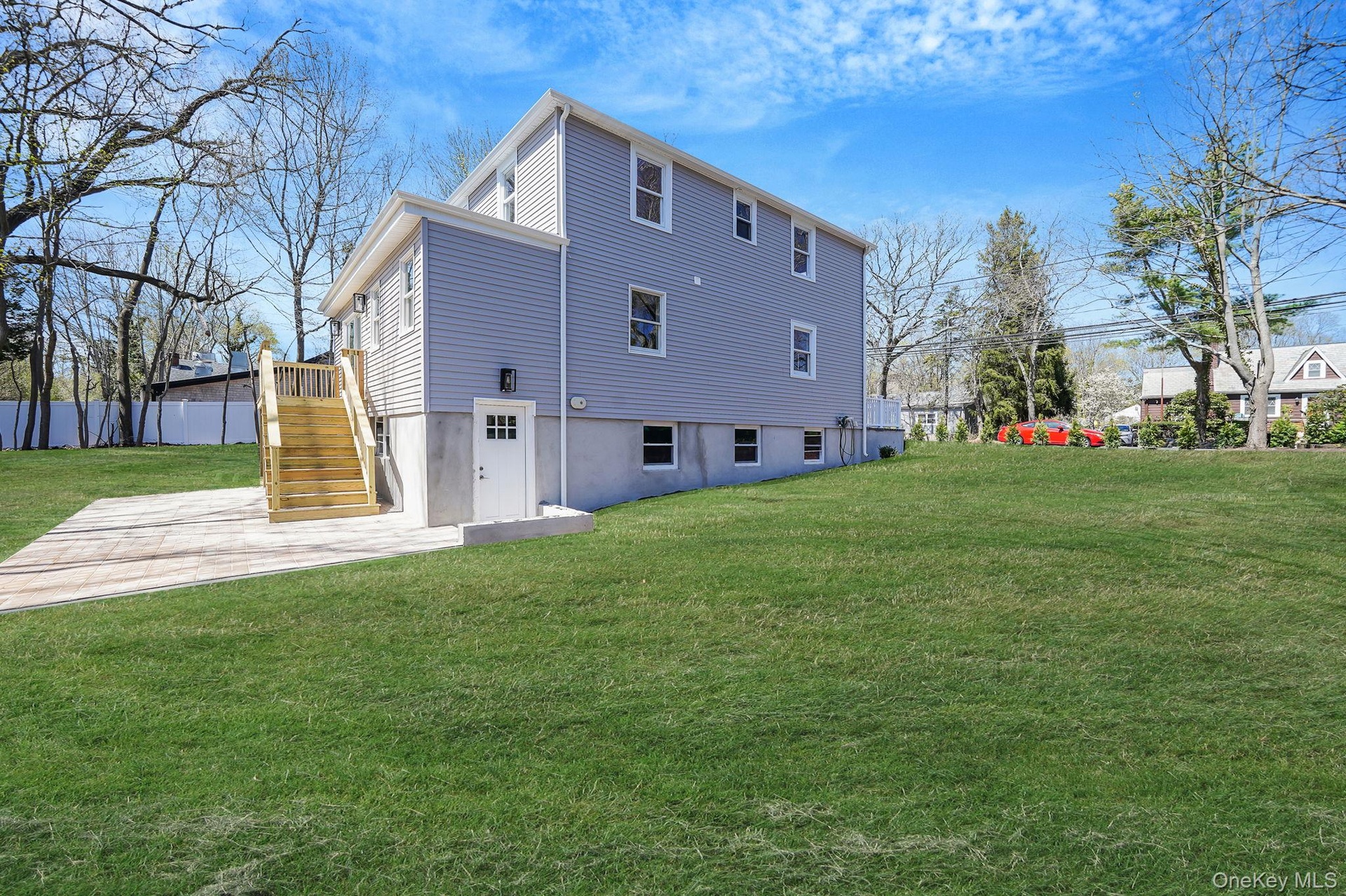Back of property with stairway and a patio