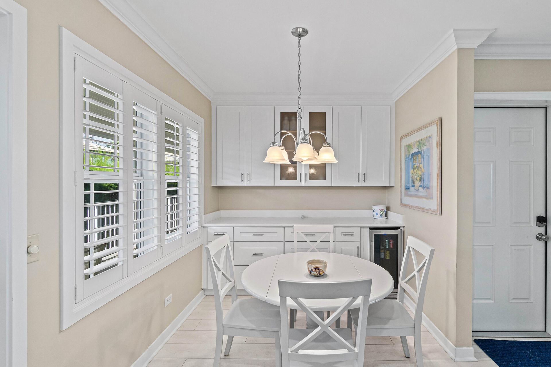Separate dining area with extra storage and chandelier.