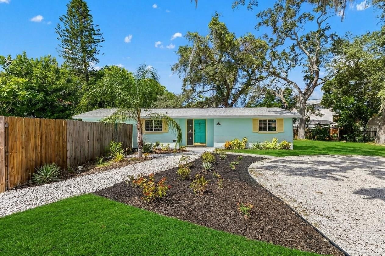 Welcome home to OZONA! A NEW ROOF (2024), cheerful coastal exterior, expansive driveway, and gated access to the fully fenced pool area set the stage 