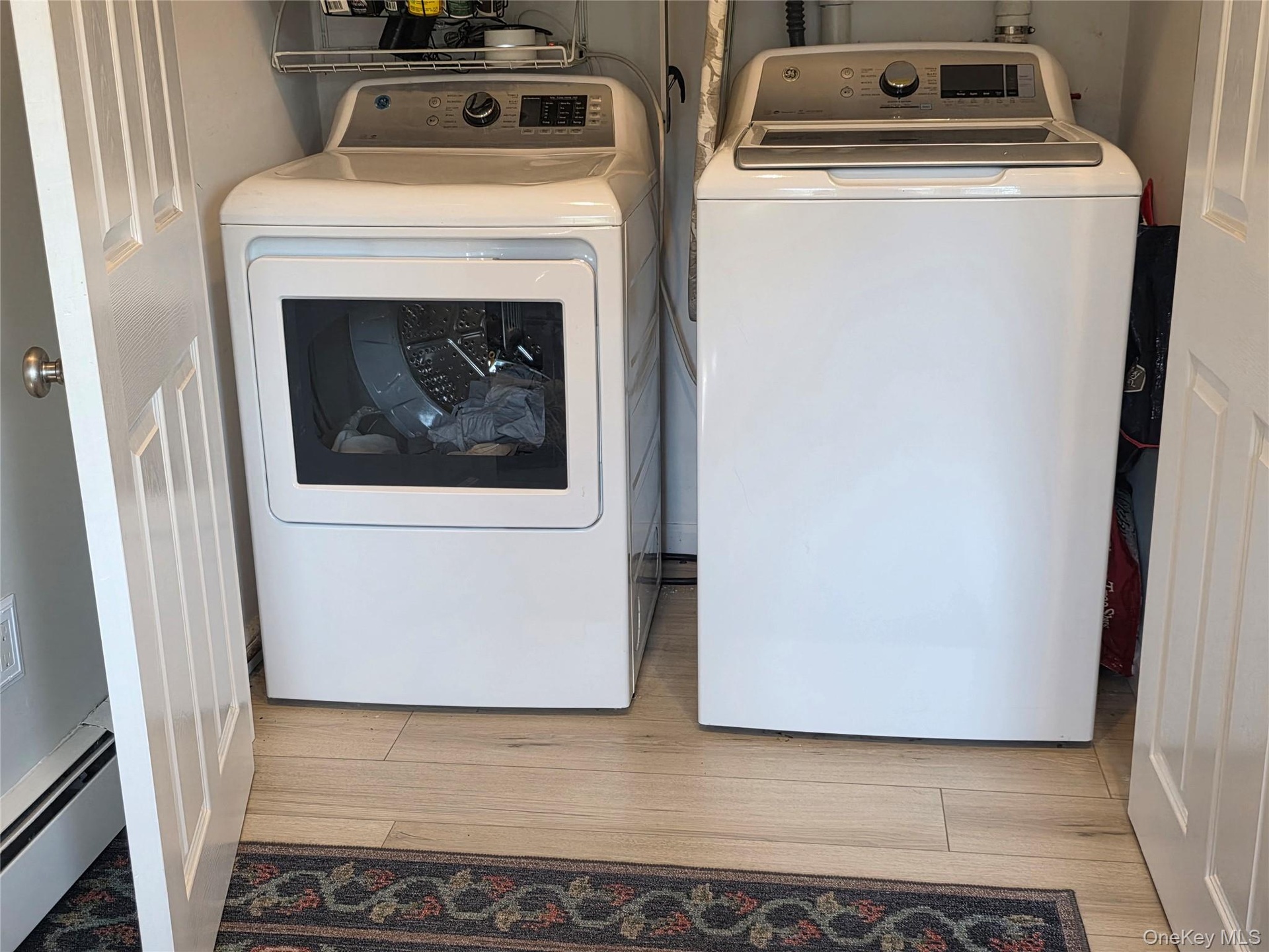 Built in Laundry Closet with full size GE washer & dryer and extra storage above!