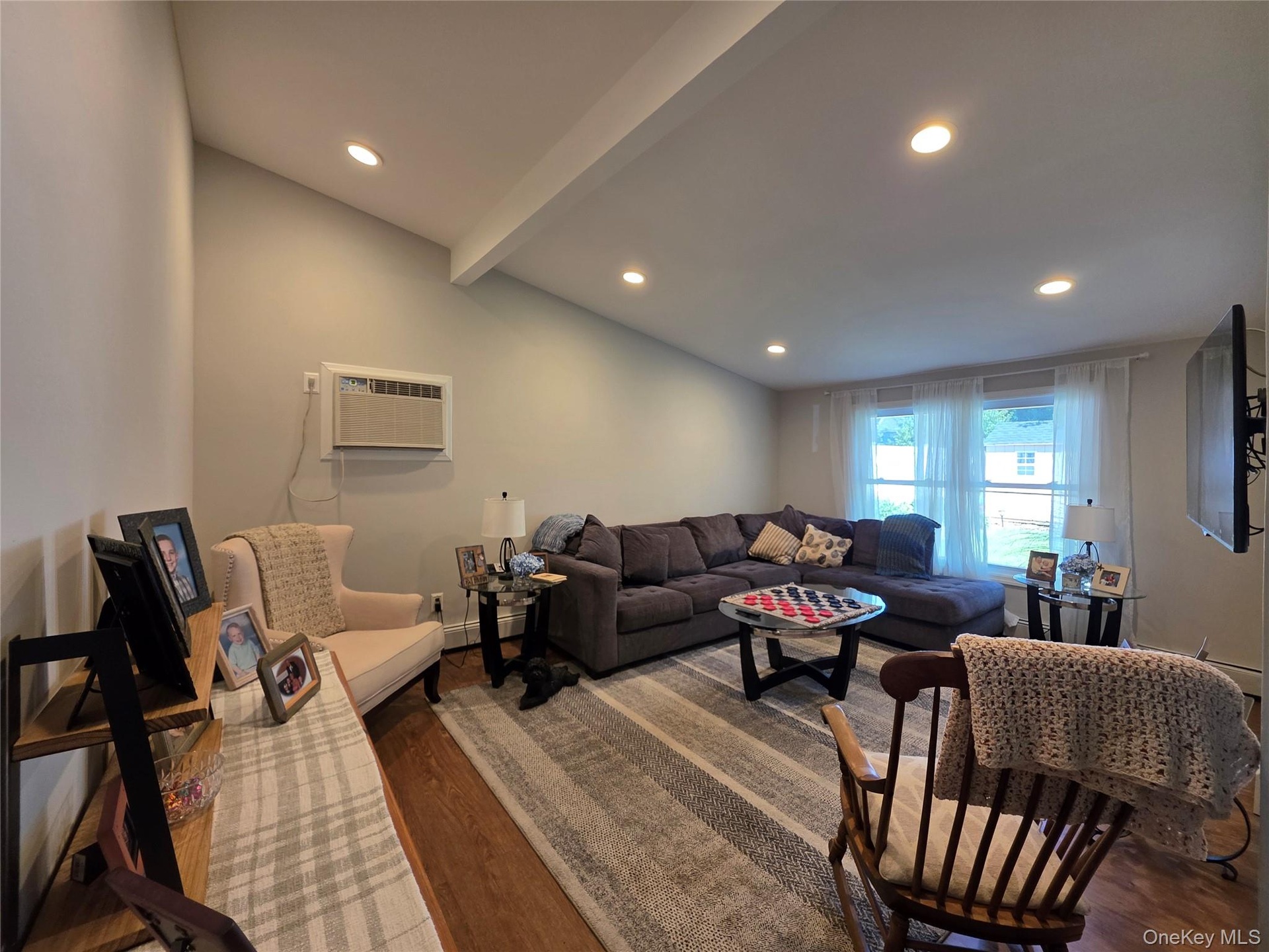 Oversized Den with Cathedral Ceiling & recessed lighting & lots of natural light & double hung windows & 1 A/C wall unit.