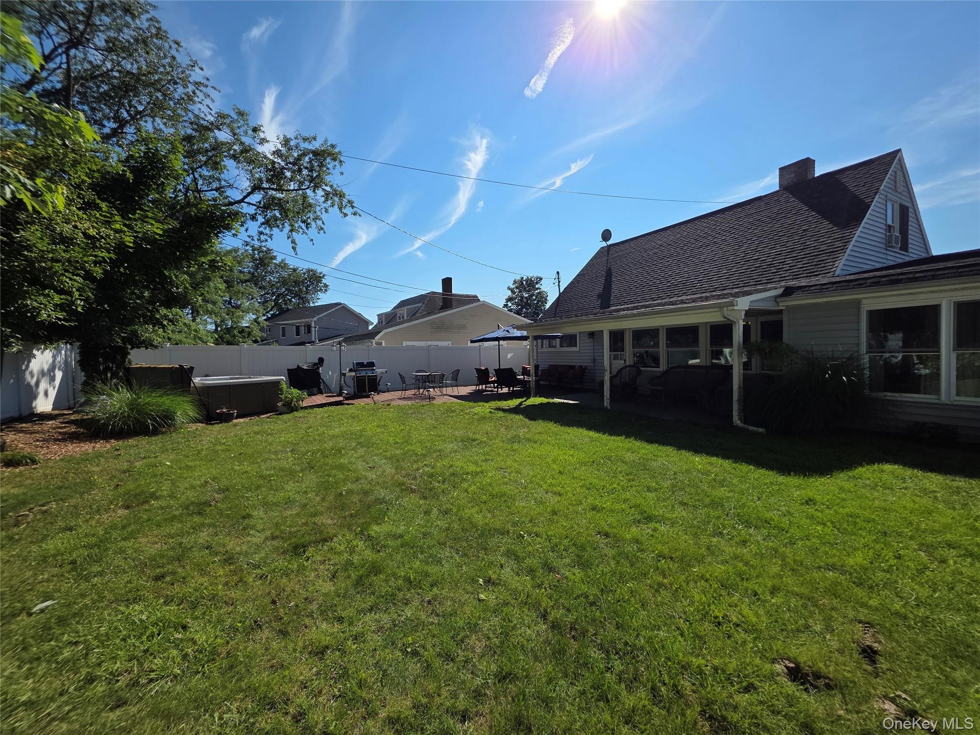 Fully Fenced Backyard with vinyl fencing and a covered patio for extra shade!