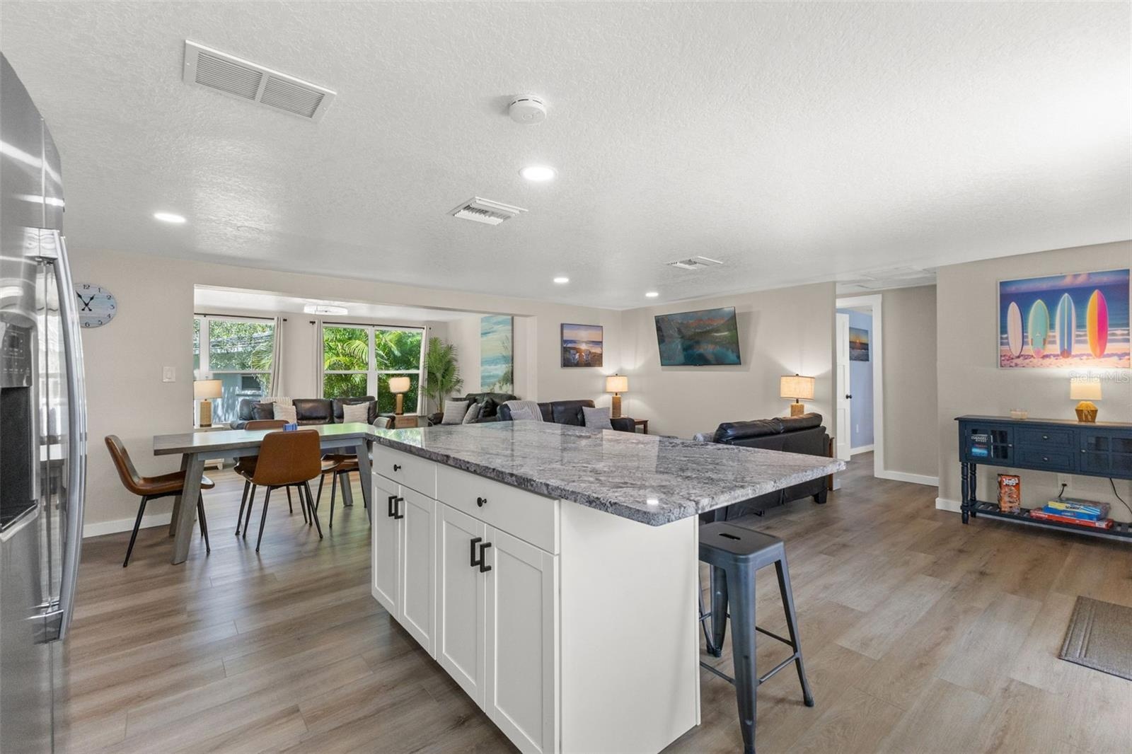 The large kitchen island anchors the open floor plan, connecting the kitchen to the dining and living areas.