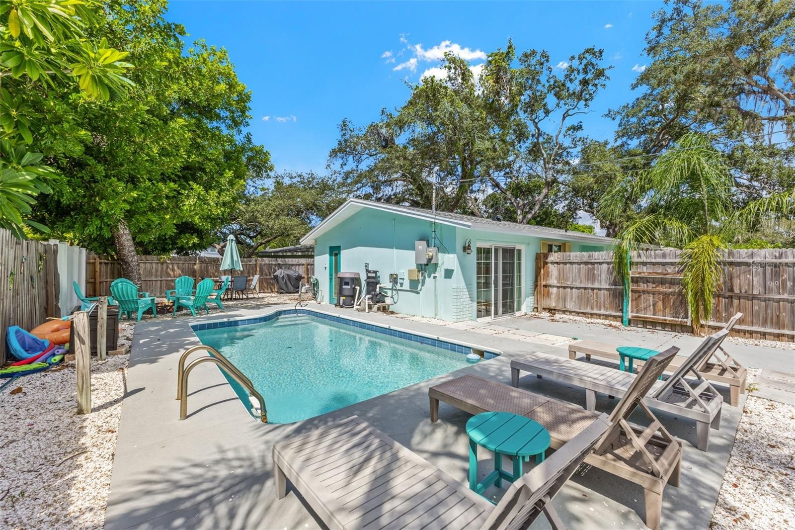 Private pool and patio create an easy outdoor extension of the home, with mature trees providing a natural backdrop.