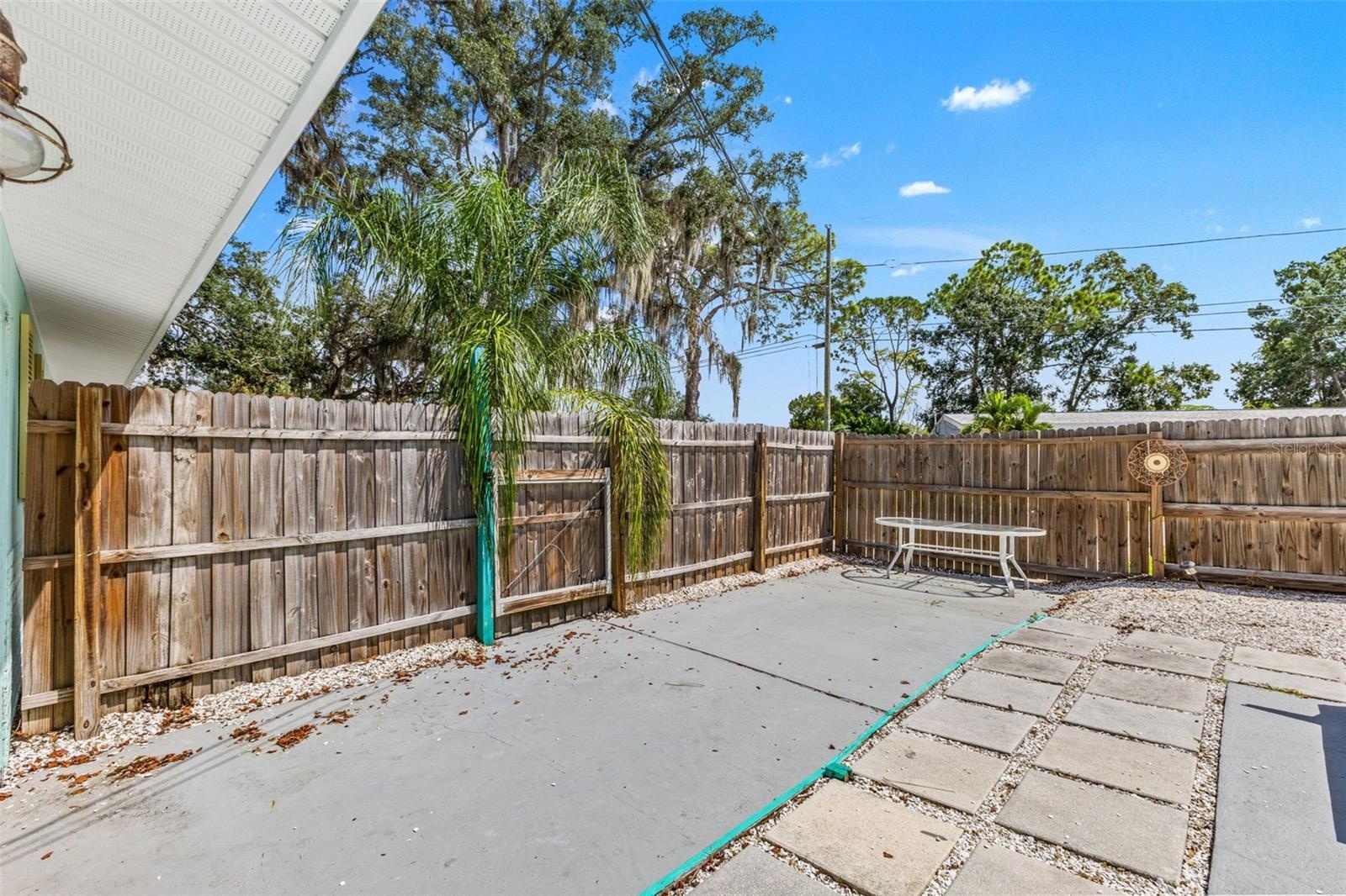 Additional fenced patio space offers even more room for outdoor dining, grilling, or creating a separate sitting area.