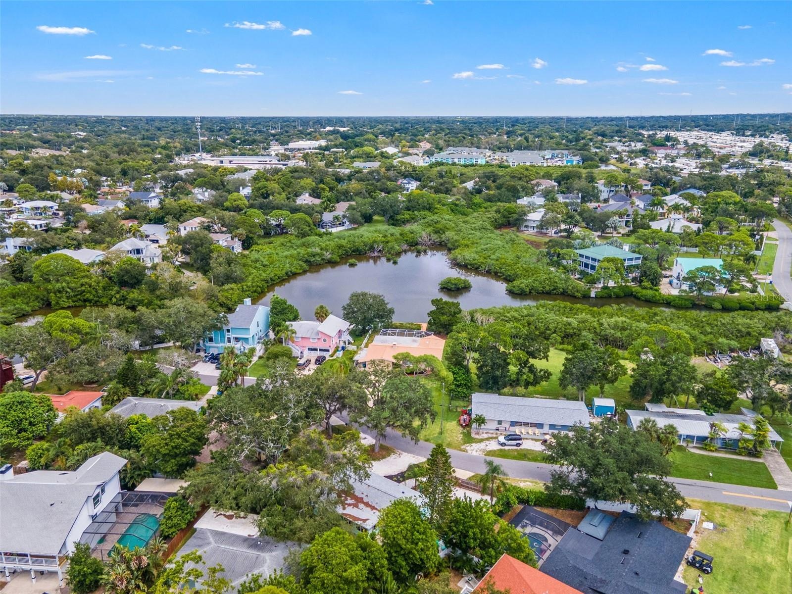 Aerial view of the surrounding Ozona neighborhood, with waterfront homes, natural waterways, and marinas nearby.