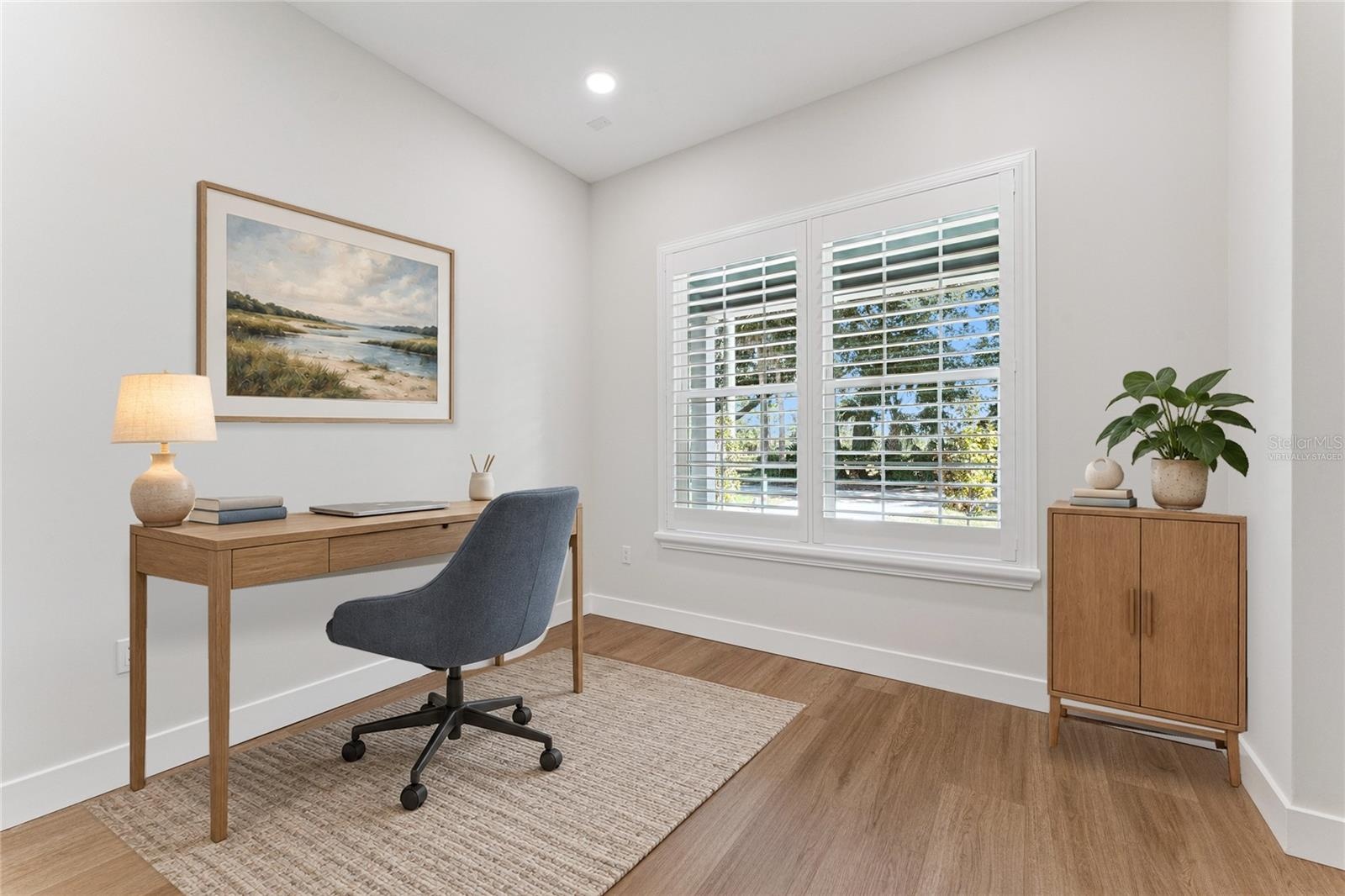 Virtually Staged - Paired shuttered windows bring natural light into this first floor office.