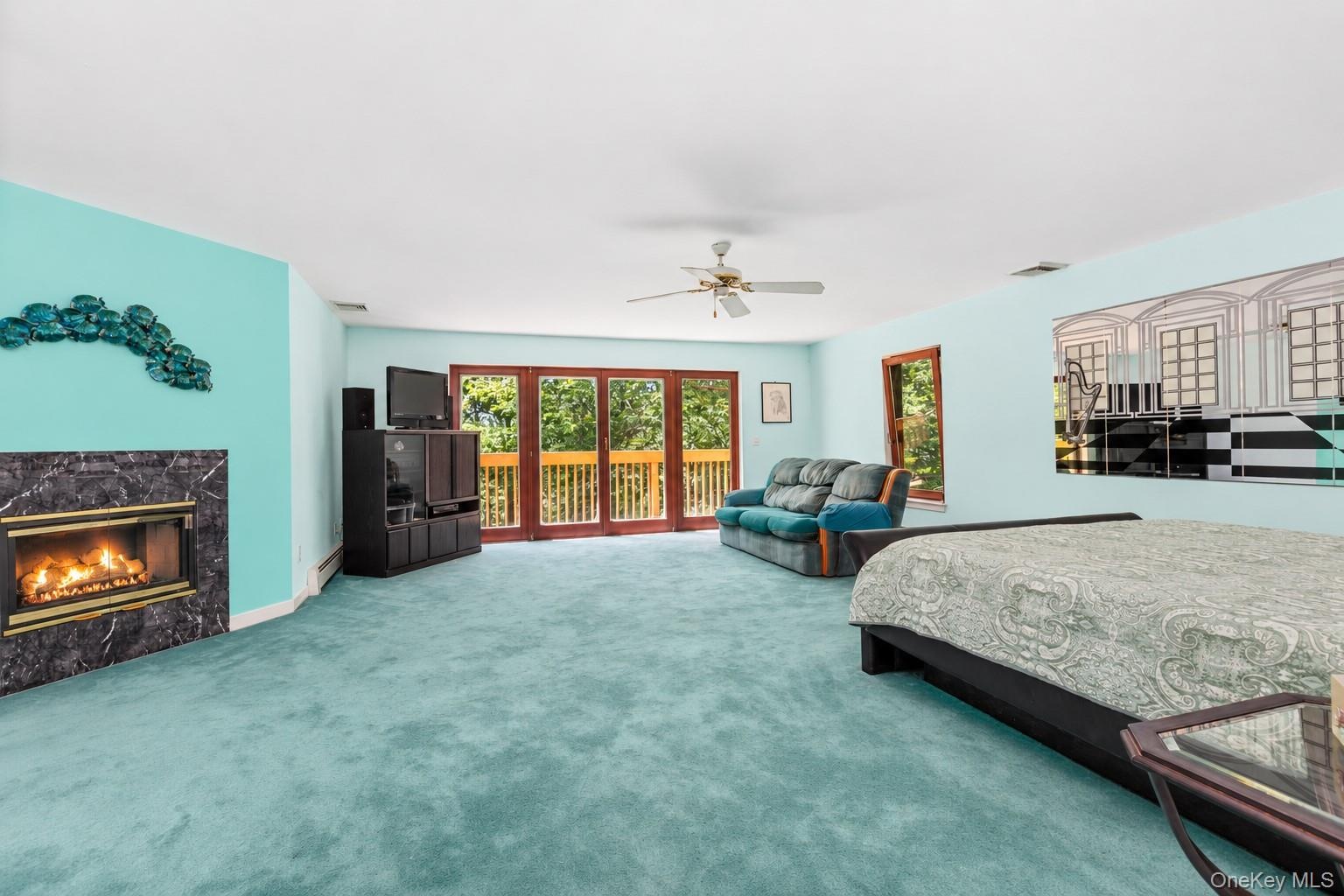 The spacious primary bedroom is privately situated upstairs, offering a peaceful and inviting retreat to relax and unwind at the end of the day.