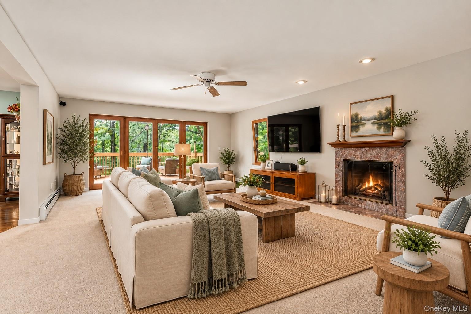 Virtually staged to showcase the living room’s contemporary comfort and generous proportions, highlighting the beautiful fireplace and expansive mahog