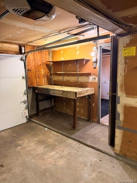 garage with door to inside. separate space for work bench