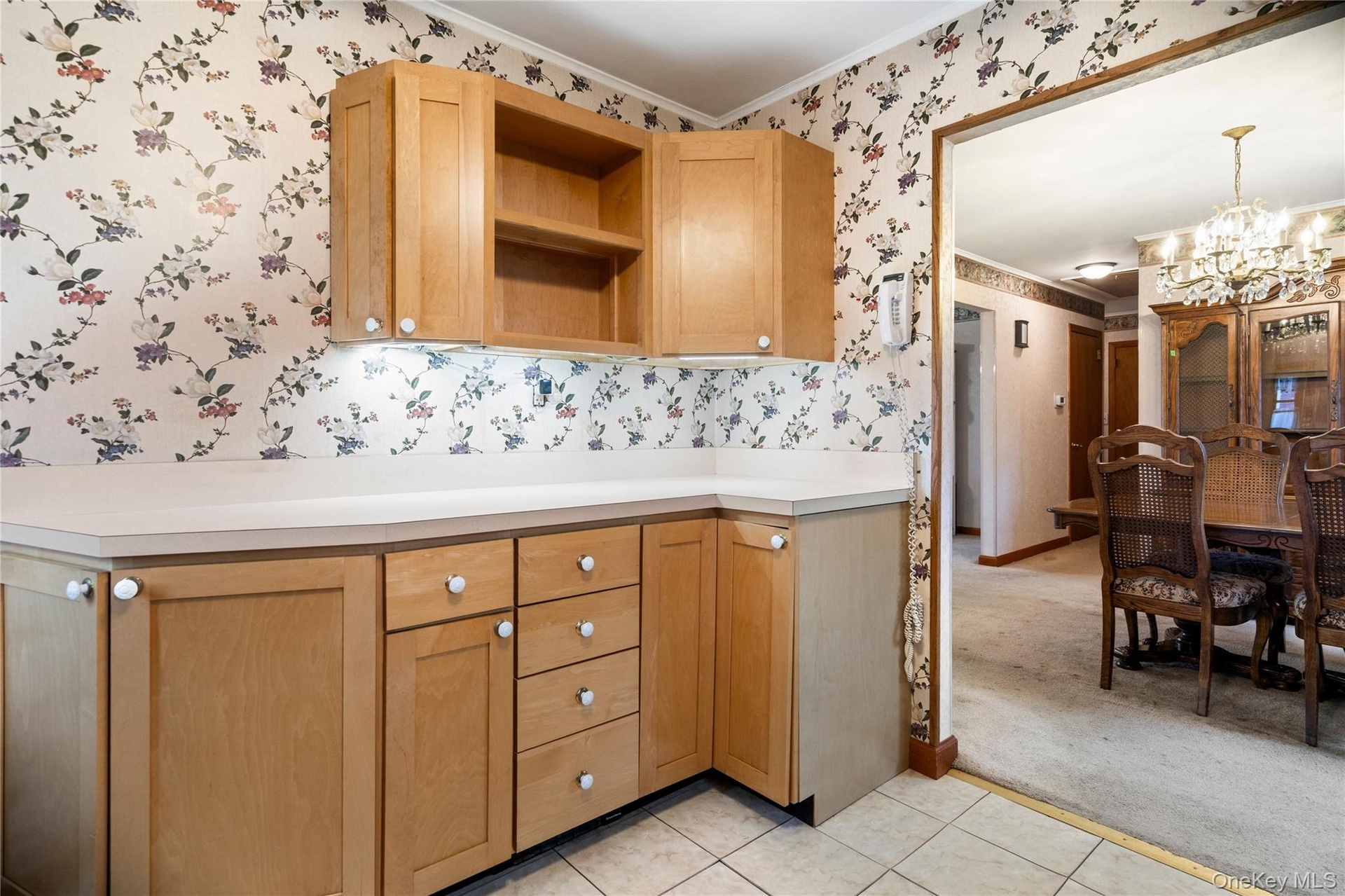 The kitchen has additional wood cabinets with formica counters for extra storage and prep space.