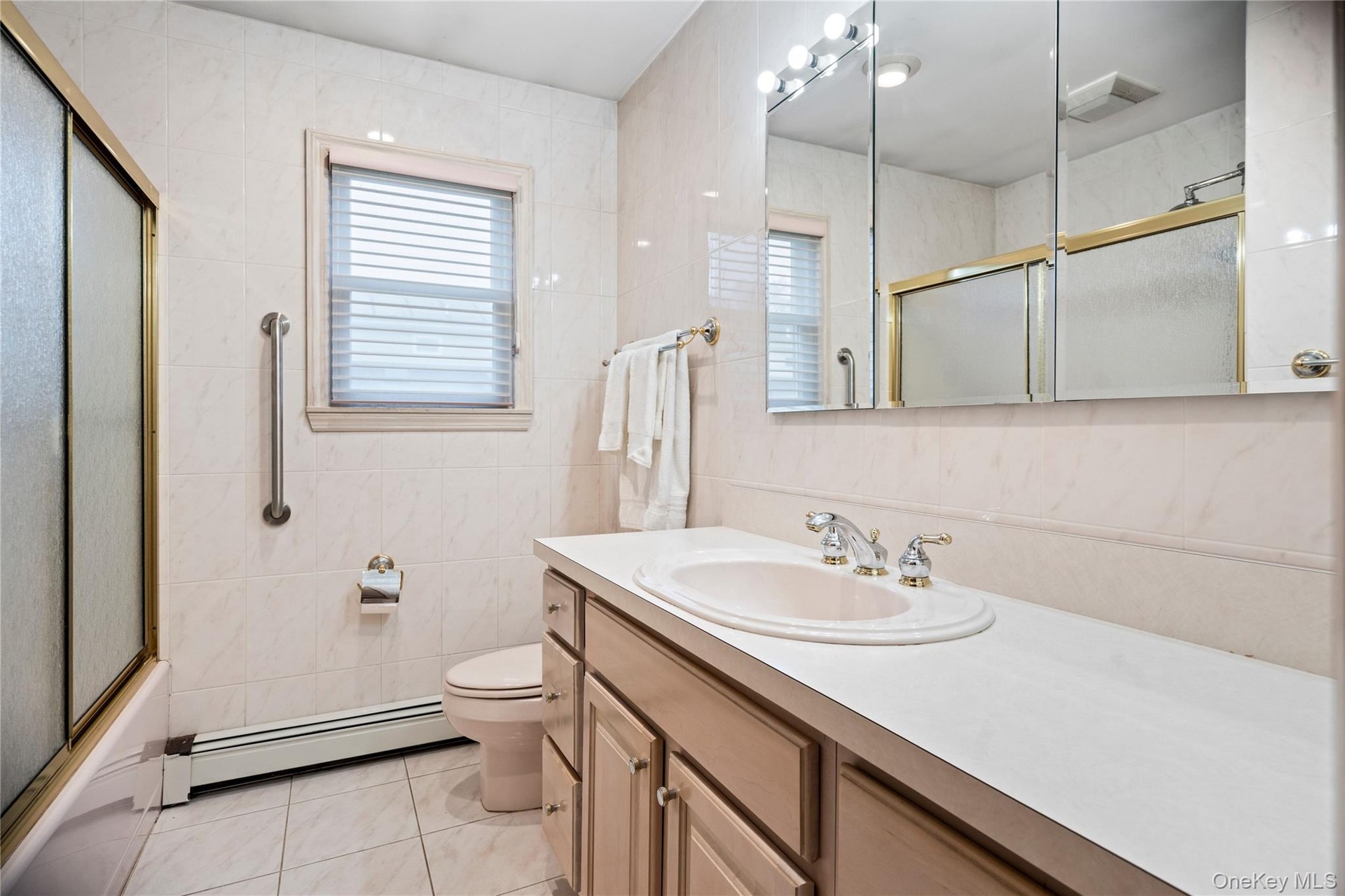 The hallway bath features a large vanity & a shower/tub.