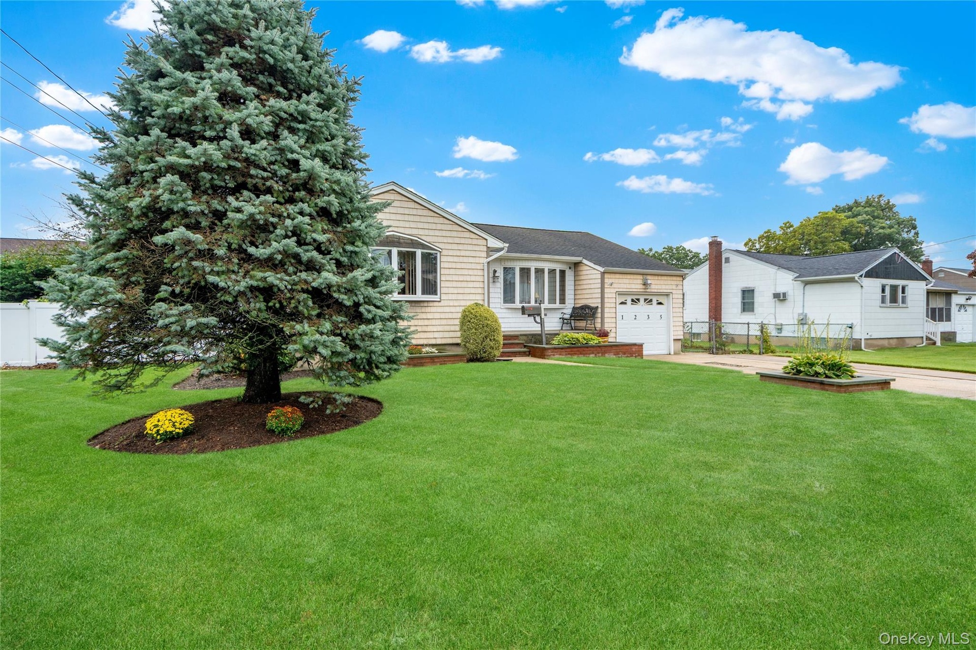 ...and the front of the home has vinyl shake siding (approx. 20 yrs) and mature landscaping with in-ground sprinklers.