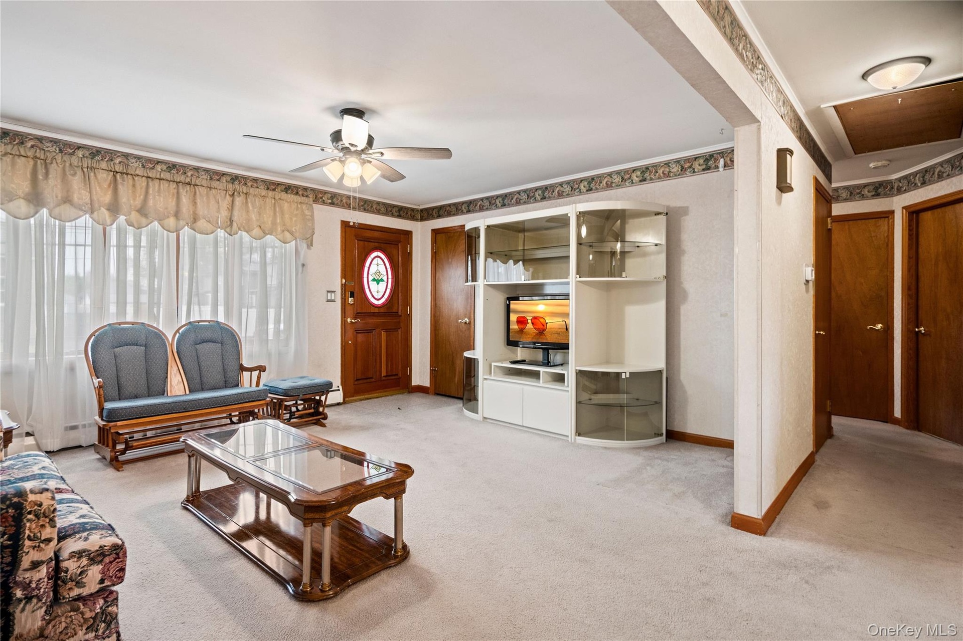 Off the living room & dining room is the hallway leading to the bathroom, bedrooms & the basement stairs.