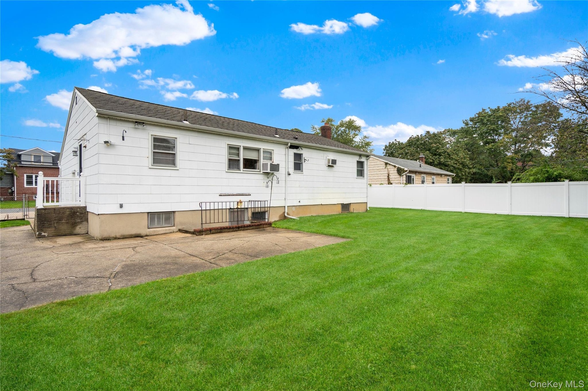 Here is a view of the backyard, looking towards the rear of the home and the side access porch off the kitchen.