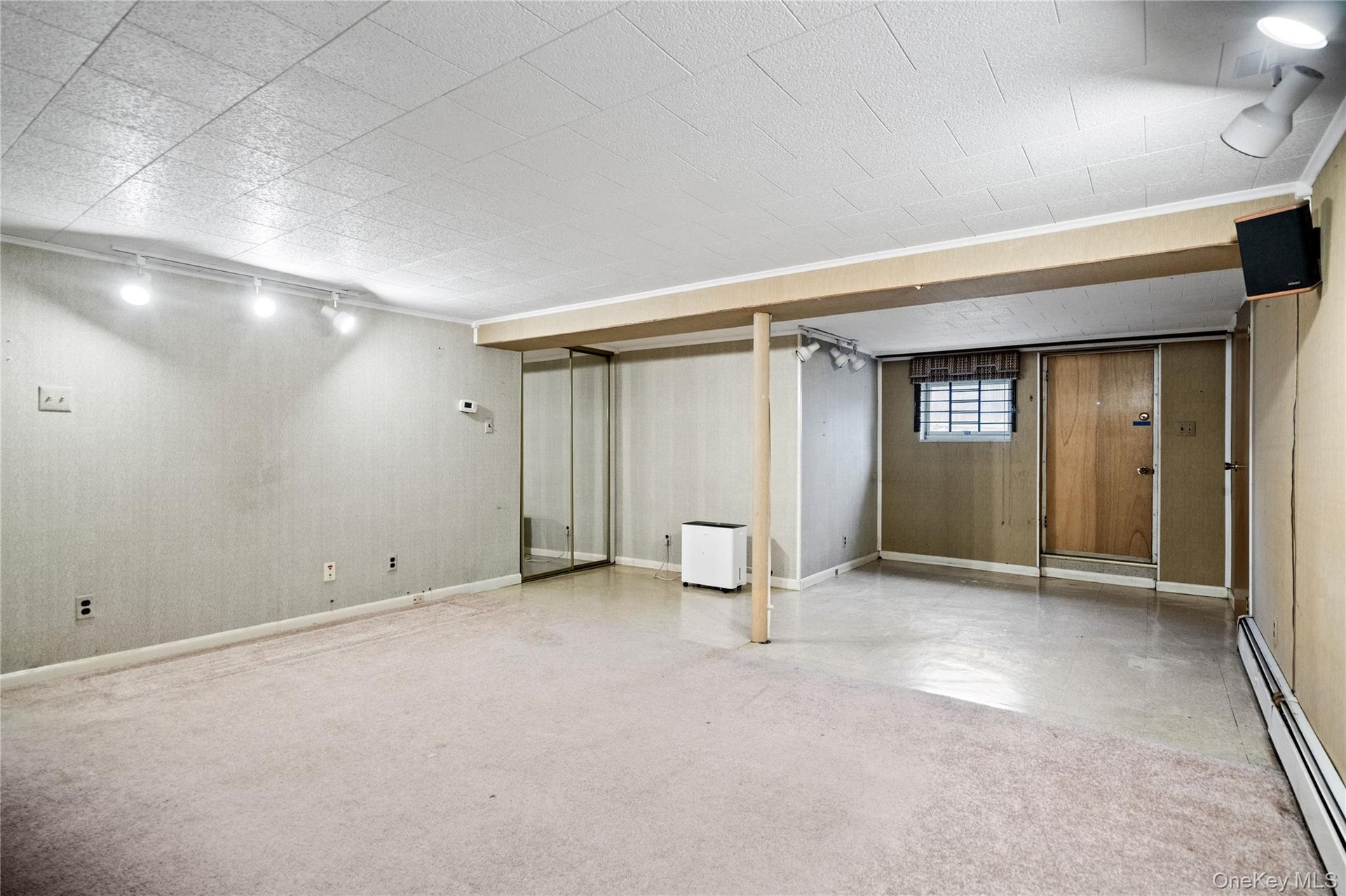 The area to the left of the stairs has multiple closets & an outside entrance.