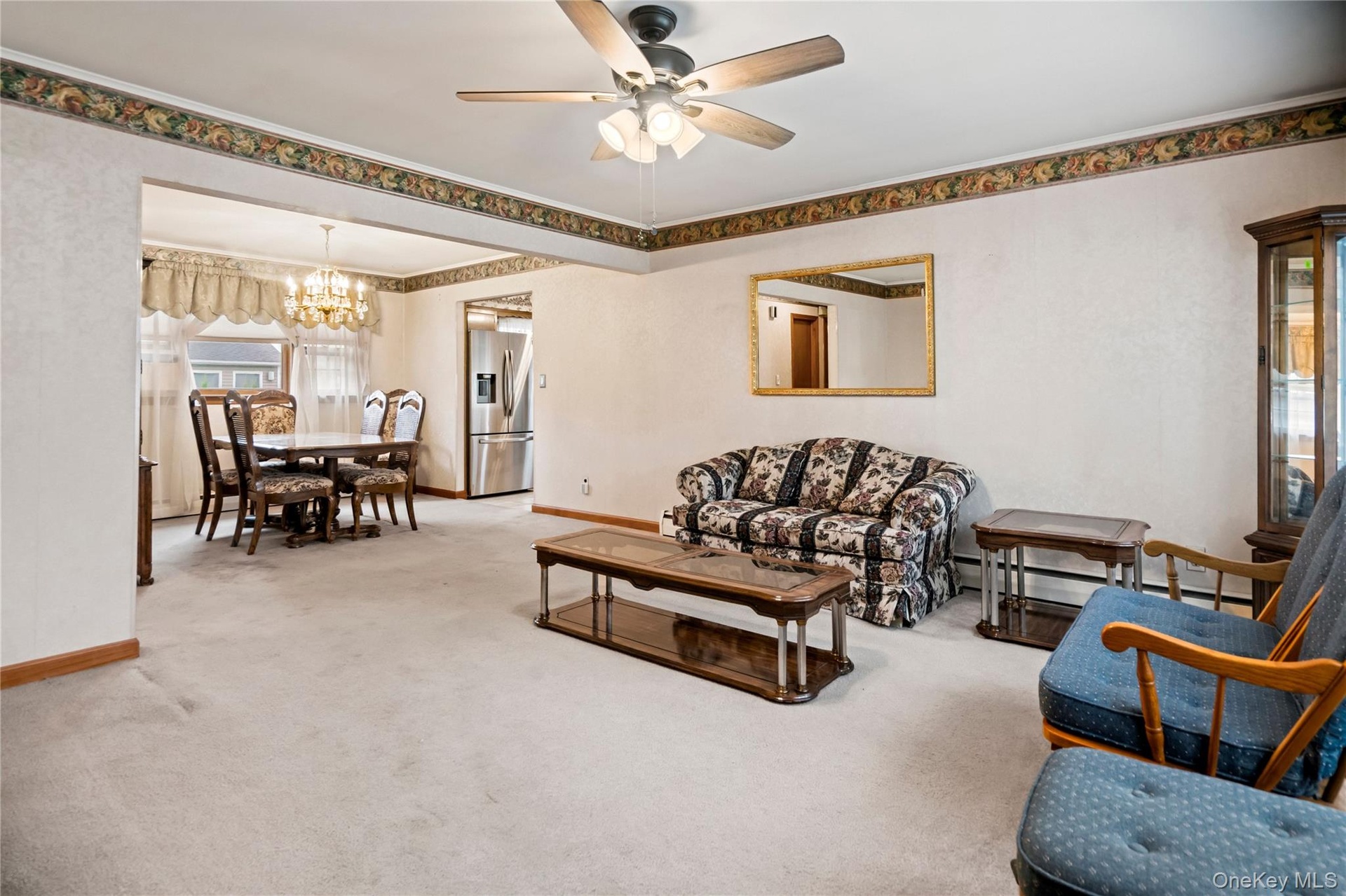 Looking from the front entryway, through the living room and towards the dining room & kitchen.