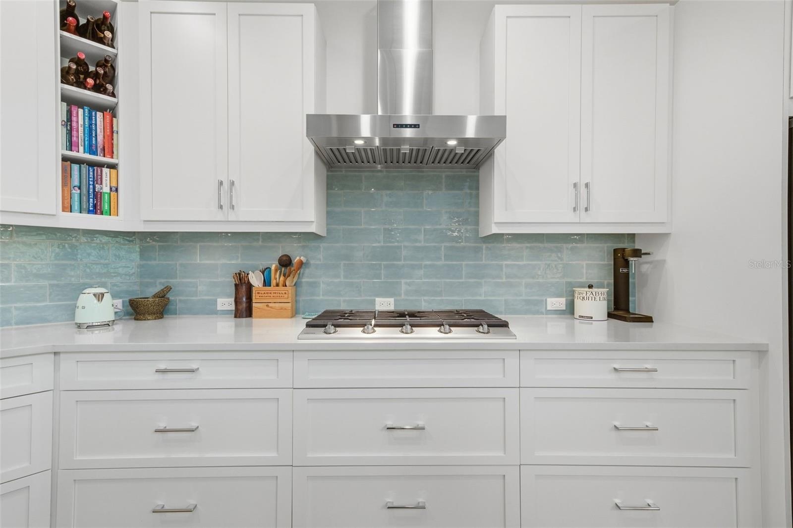 Gas cooktop, exhaust hood and custom depth counter tops to allow for more prep space