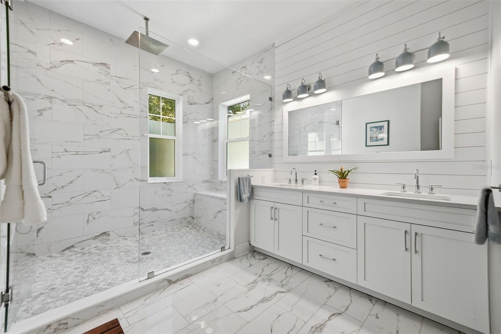 Huge primary bath with double sinks, an oversized shower and plenty of natural light