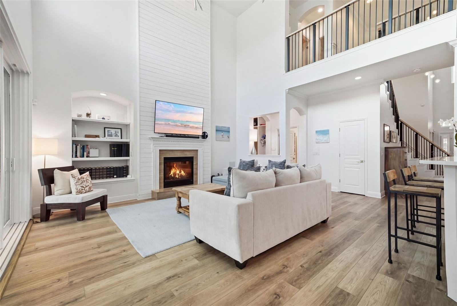 Featuring shiplap, built in shelving & a gas fireplace, the family room is open to the kitchen & breakfast area