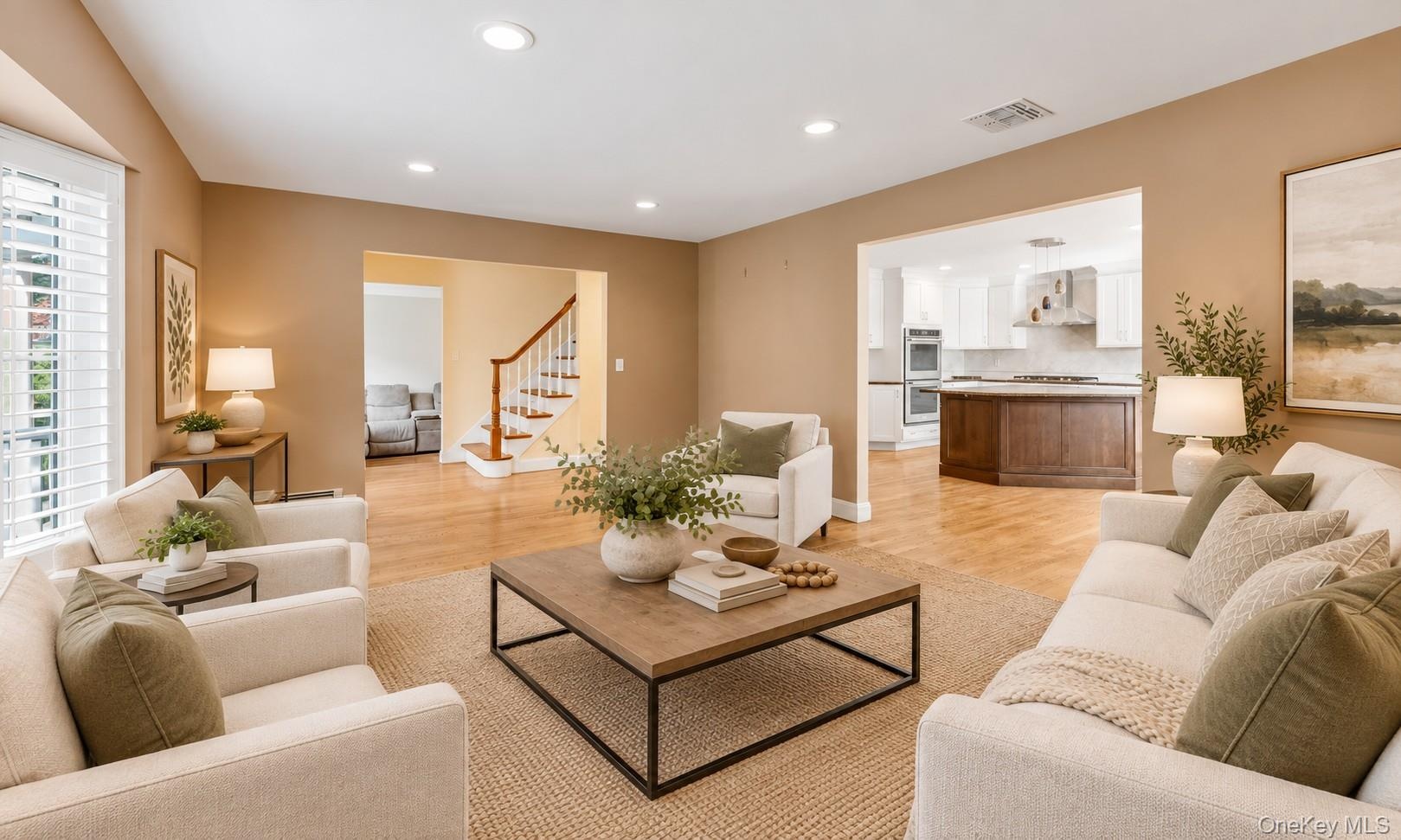 Entry to Upstairs and Living Room to Kitchen virtually staged