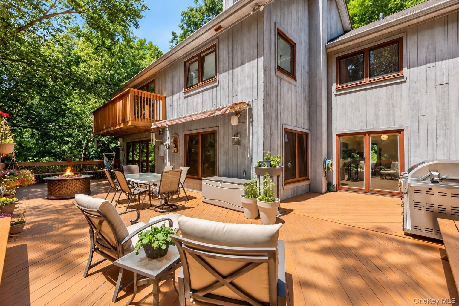 A wraparound deck extends seamlessly from the main-level living space, creating an inviting outdoor extension where thoughtful design and nature beaut