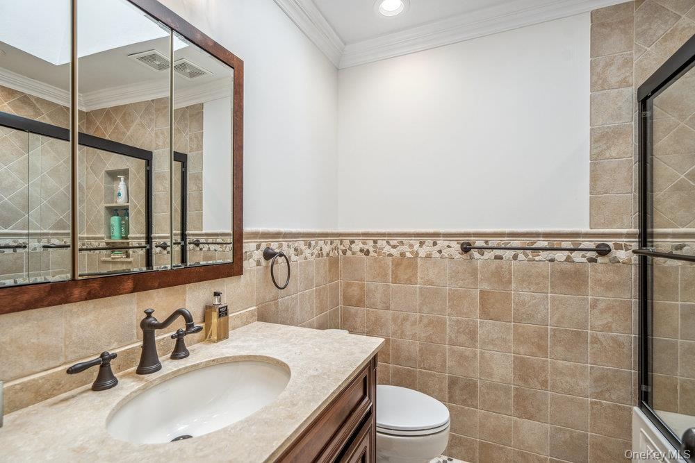 Vanity with integrated sink, dark bronze-finish faucet, and stone countertop