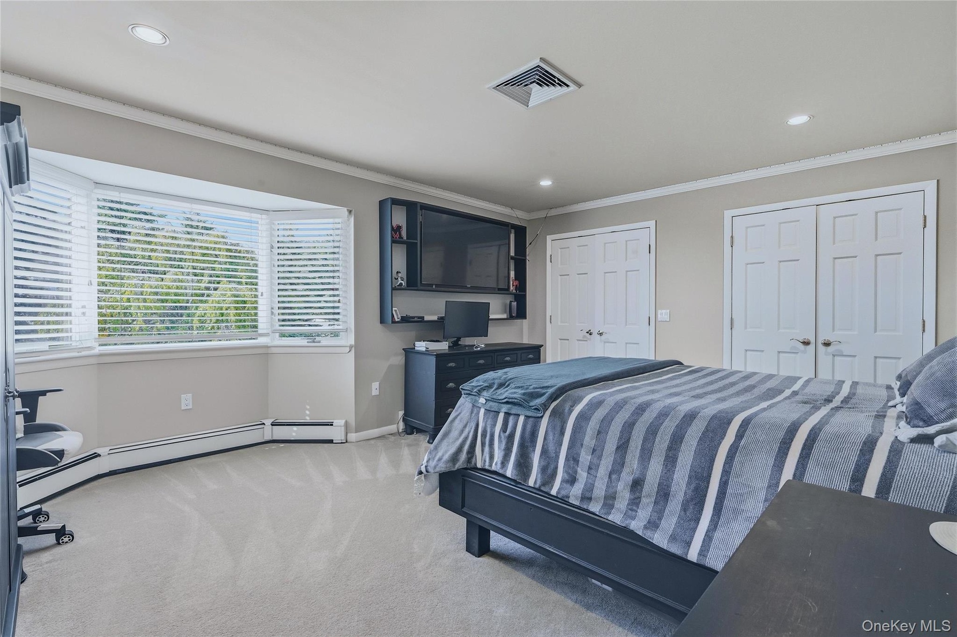 Bedroom 3, bay window with blinds, recessed lighting, crown molding, and two panel doors